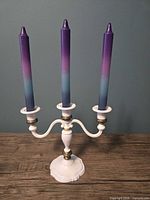 Candelabra upright with three taper candles inserted