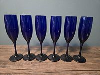 Front view of six cobalt blue champagne flutes