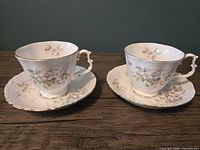 Two Royal Albert Haworth teacups each on matching saucer