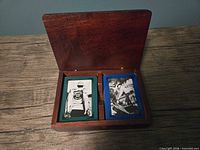 open box showing two decks inside felt-lined compartments