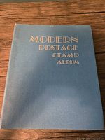 Front cover of blue Modern Postage Stamp Album