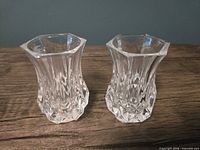 Two small clear glass bud vases—side view highlighting faceted bodies and rim shape