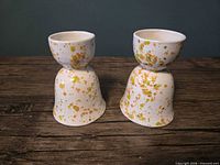 Front view of both egg cups showing speckle pattern and shape