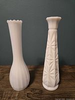 Front view ribbed and starburst milk glass vases