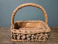 Oblique view showing basket shape, handle, decorative side trim