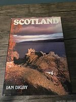 Front cover of hardcover book with dust jacket showing castle and title Scotland