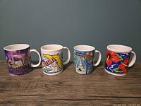 Group shot of four souvenir mugs side by side