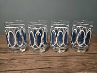 Front view of four tumblers standing upright showing full geometric pattern