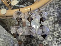 Top view of six clear ribbed glass knobs with metal bases