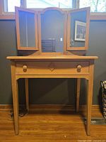 Full view of vanity showing mirror, drawer, legs