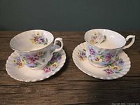 Two Royal Albert teacups each on its saucer showing pattern and shapes