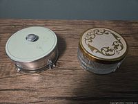 Top view of both glass powder jars displaying lid designs