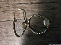 Both wristwatches side by side showing cases and bracelets