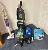 Group shot showing upright extractor, steam mop, steam zapper box, solutions and tools