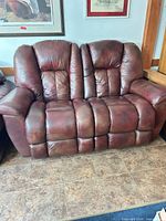 Front view of bonded leather reclining loveseat showing cushions and overall appearance
