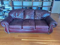 Front view of burgundy leather 3-seater sofa