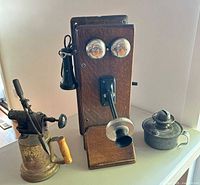 Group shot of oak telephone, blow torch and oil lamp