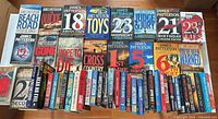 Overhead of entire lot laid out on floor showing approximately 50 books, mix of formats