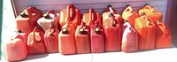 Front view of all plastic fuel cans lined up