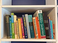 Entire shelf showing approximately fourteen reference books