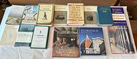 All eleven books laid out in two rows showing fronts and spines