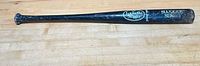 Full view of Louisville Slugger black wood bat