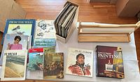 Overview of all items on table: books, Learn & Master Painting set, vinyl record box, wooden paper holder