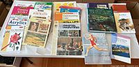 Full table view of approximately ten art, gardening and fitness books