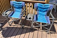 Two blue/navy Timber Ridge folding chairs side by side on deck showing overall design