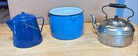 Front view of coffee pot, stock pot, and metal tea kettle