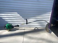 Full view of Weed Eater FeatherLite XT260 string trimmer on table