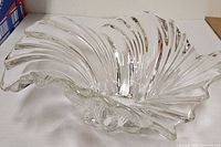 Oblique view showing clear glass wave swirl design and flared edges