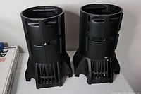 Two black ETC Source Four 19° lens tubes standing upright