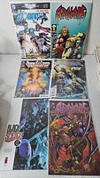Six comic books laid out: Stormwatch, Araknis, Black Science, additional Stormwatch