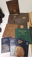 Group shot of all coin albums and folders on table