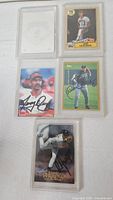 Group of five autographed cards in protectors