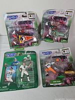Group shot of four sealed Starting Lineup figures