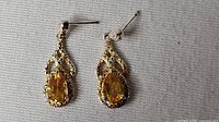 Front view of both earrings showing design and stones