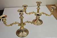 Pair of brass candelabras showing overall form and number of arms