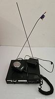 Top view of Shure LX receiver with antennas, microphone and power adapter
