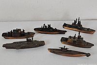All six bronze-tone diecast naval vessel miniatures on display
