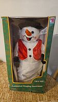 Front view of boxed animated singing snowman showing full figure and packaging