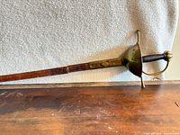 Full view of rapier with scabbard on table