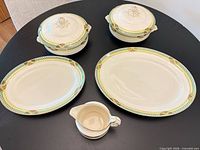 Group view showing two covered tureens, two platters and gravy boat