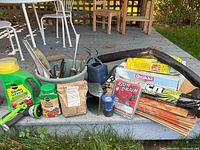 Entire lot arranged on deck showing all tools, fertilizers, bags, weed barrier, hose parts