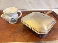 Shaving mug and crumb catcher side by side on tray