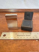 lighter, leather case, ruler for scale