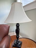 Full view of lamp on side table showing shade, base and overall style