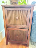 Front view showing two grooved drawers, walnut veneer, knobs and legs