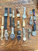 All 18 wrist watches laid out on table